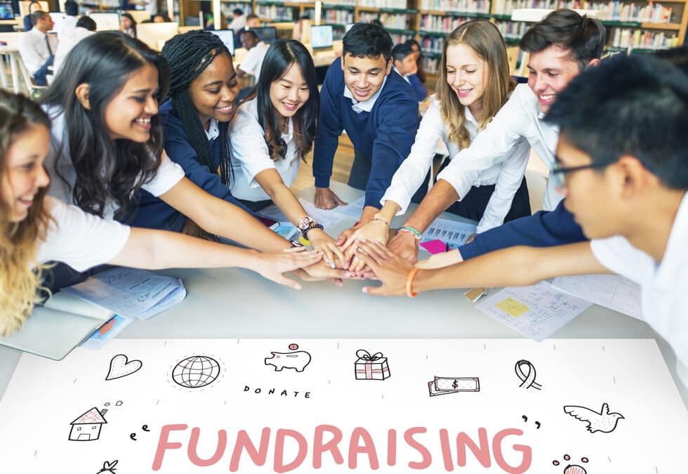 People Gathering Their Hands In A Circle Running A Fundraiser